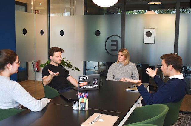 Source: Unsplash. Meeting room filled with people